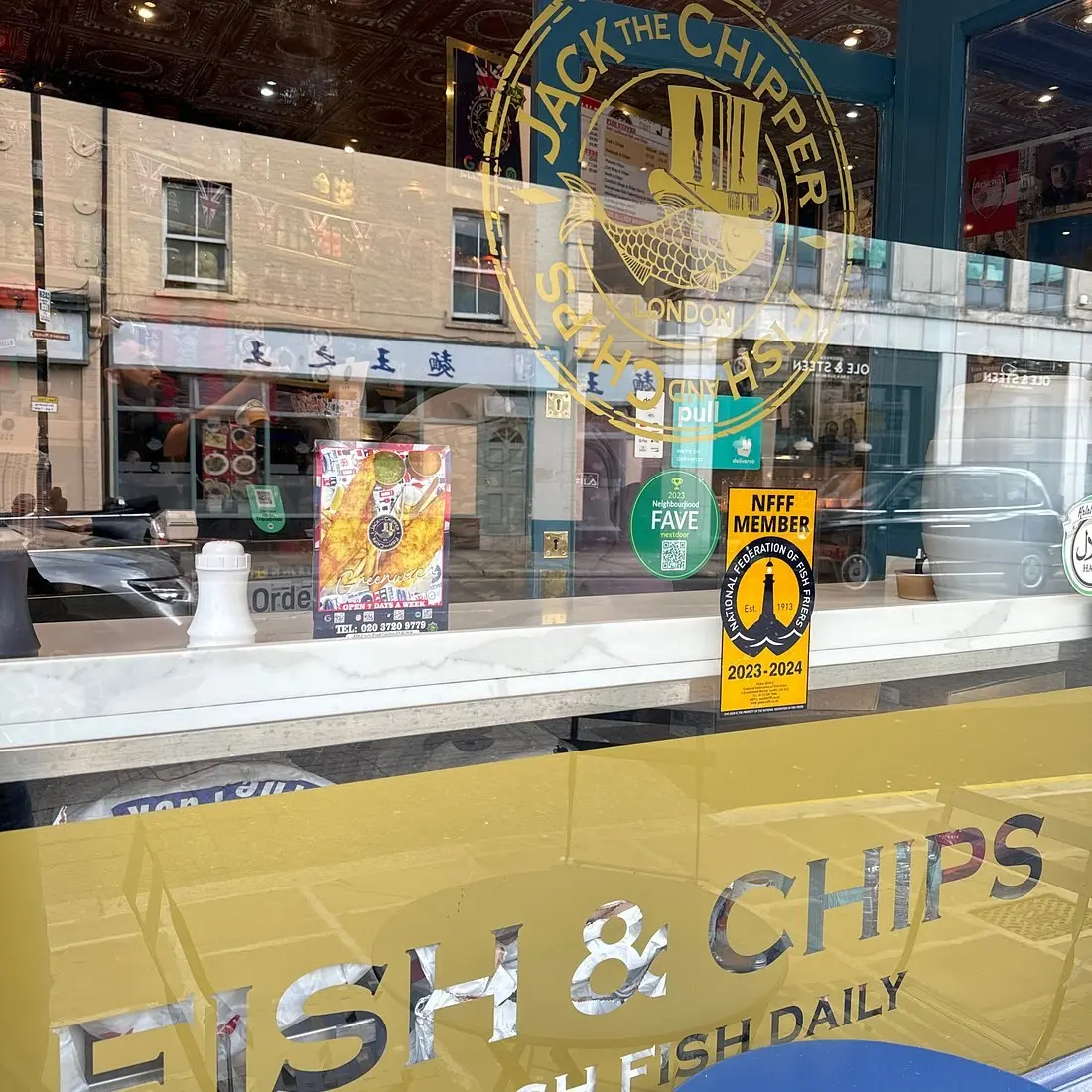 The shop window with the Fish & Chips, Fresh Fish Daily lettering